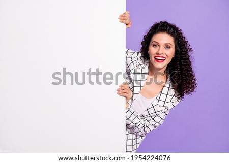 Photo of young cheerful girl happy positive smile hold paper poster banner advert advise isolated over purple color background