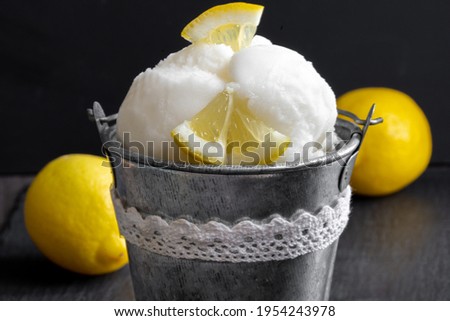 lemon ice cream in a bowl fruits dark background