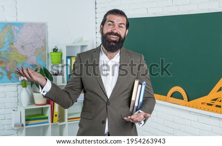 brutal unshaven guy university lecturer in classroom, education