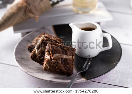 Caramel Cake , Pie, with caramel and chocolate slices in the top and coffee on white wood background 