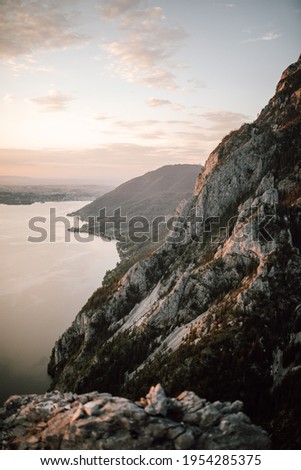 Beautiful view from top of a mountain in Austria at sunset in summer - enjoy the picturesque landscape with the view of a big lake and colorful clouds