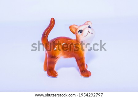 Ceramic orange cat on white background