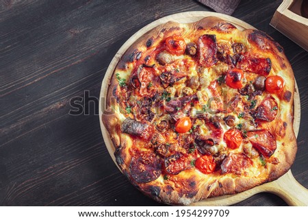 Homemade pizza with salami and mushrooms, top view with copy space