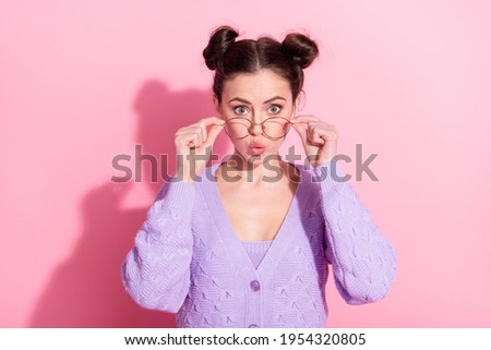 Photo portrait of amazed funky girl in glasses wearing violet cardigan isolated on pastel pink color background