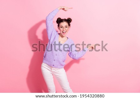 Photo portrait of funky girl laughing showing fingers empty space isolated on pastel pink color background