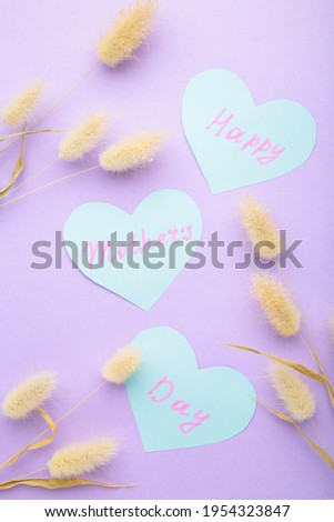 Mother's day card with flowers on purple background. Top view