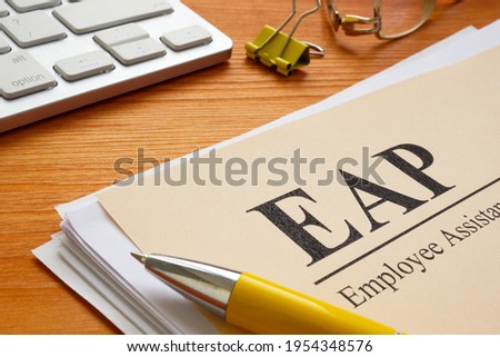 Stack of papers about EAP Employee Assistance Programme or Program. Royalty-Free Stock Photo #1954348576