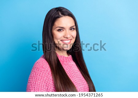 Profile portrait of half turned attractive girl toothy smile look camera wear pullover isolated on blue color background