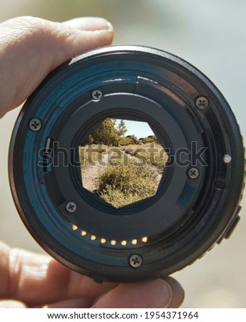 landscape of a dirt road seen from behind a camera lens