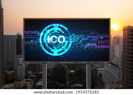 ICO hologram icon on billboard over panorama city view of Bangkok at sunset. The hub of blockchain projects in Southeast Asia. The concept of initial coin offering, decentralized finance