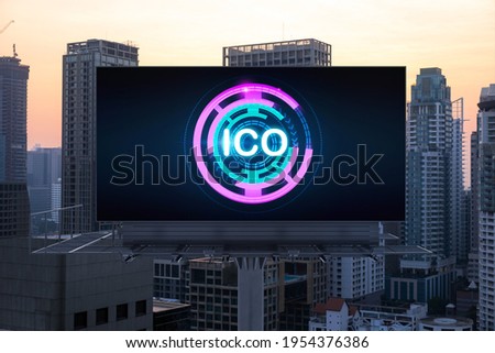 ICO hologram icon on billboard over panorama city view of Bangkok at sunset. The hub of blockchain projects in Southeast Asia. The concept of initial coin offering, decentralized finance