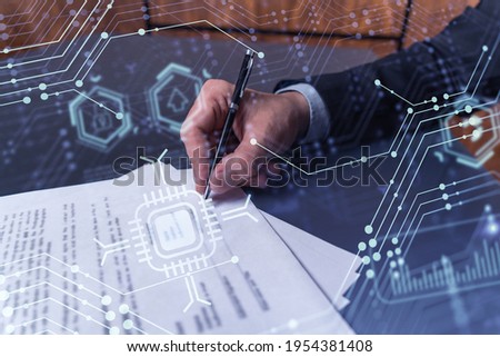 A client in dark blue suit is signing a contract to create a new software to present it in start up conference and gain investments to create a product. Technological graph over the desk.