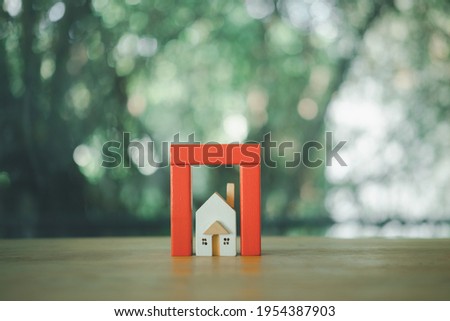 Protects the house with red dominoes. Home insurance or house insurance concept.