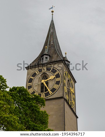 Saint Peter church clock tower under cloudy sky in Zurich, Switzerland