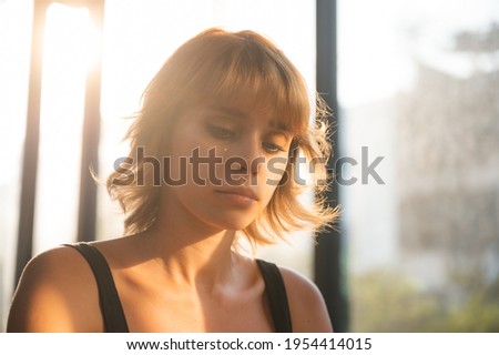 portrait woman model with coiffure gold hair fashion style, beauty make-up girl styling her hair, making hair style with sunset, female face enjoy to create and setting hair style