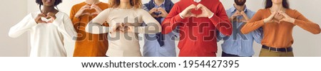 Group of thankful youth and senior citizens showing love and support and sending gratitude. Banner with midsection shot of young and mature people doing heart shape hand gesture