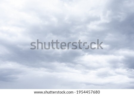 Cloudscape scenery, overcast weather above dark blue sky. Storm clouds floating in a rainy dull day with natural light. White and grey scenic environment background. Nature view. Royalty-Free Stock Photo #1954457680
