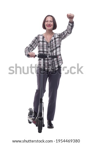 confident mature woman with electric scooter showing thumbs up.