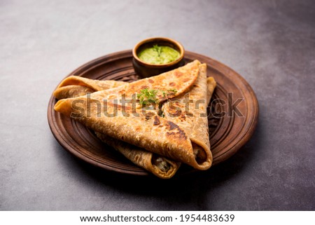 Triangle Paratha Wrap with potato chicken filling served with green chutney, Indian food Royalty-Free Stock Photo #1954483639