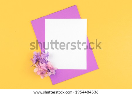 Creative flowers flat lay mockup, floral background with blank white card, copy space photo