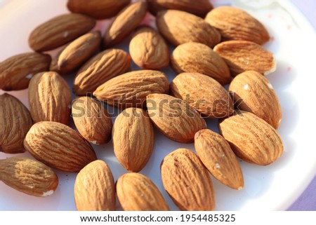 tasty and healthy brown colored almond stock on white background