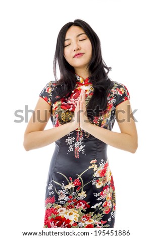 Asian young woman praying with her hands clasped