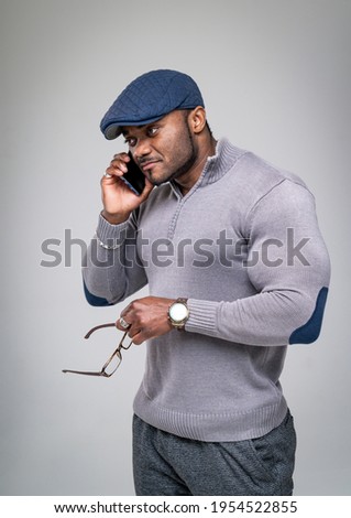 Healthy, fit and muscular black african american man. Using phone.