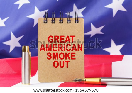 USA Holidays. Against the background of the US flag lies cardboard with the inscription - GREAT AMERICAN SMOKE ?UT