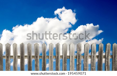 old wooden fence on a blue sky background