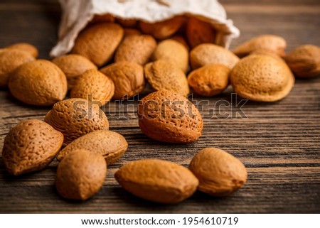 Fresh almond kernels on the wood floor. almond milk nutrition.