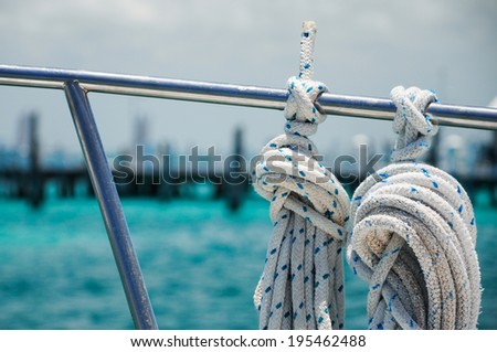 Tied ropes on a sailboat going from Isla Mujeres towards Cancun, Quintana Roo, Mexico Royalty-Free Stock Photo #195462488