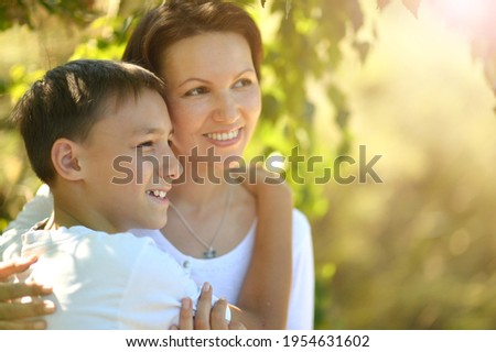 Close up portrait of beautiful mother with son in park