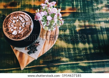 Latte on a texture table in a black cup