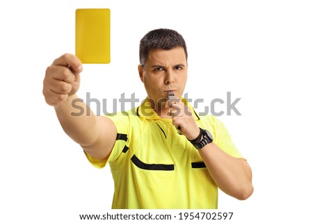 Football referee blowing a whistle and showing a yellow card isolated on white background Royalty-Free Stock Photo #1954702597