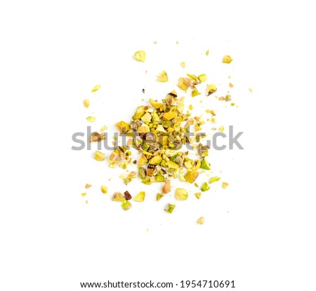 Scattered pistachio nut pieces isolated. Break chopped pistachios pile, fried baked diced pistache on white background top view Royalty-Free Stock Photo #1954710691