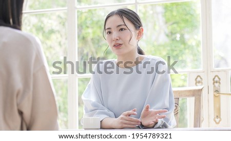 Asian women talking at home Royalty-Free Stock Photo #1954789321