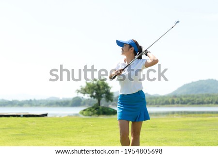 Golfer women sport course golf ball fairway. People lifestyle woman playing game golf tee of on the green grass sunset background. Asian female player game shot in summer. copy space banner