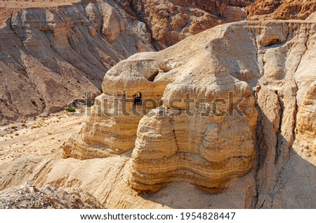 Cave of the Dead Sea Scrolls, known as Qumran cave 4, one of the caves in which the scrolls were found at the ruins of Khirbet Qumran in the desert of Israel. Royalty-Free Stock Photo #1954828447