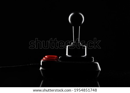 Retro joystick from 8-bit consoles. Game controller isolated on black background