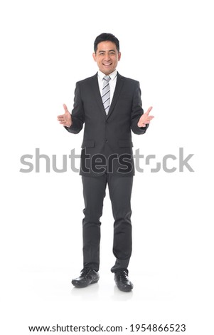 Full length portrait of young businessman with hands open palm standing on white background