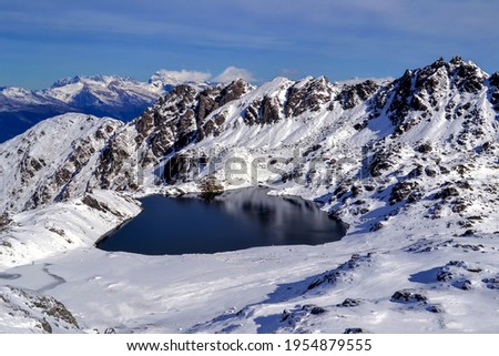 Lake on mountain surrounded by ice