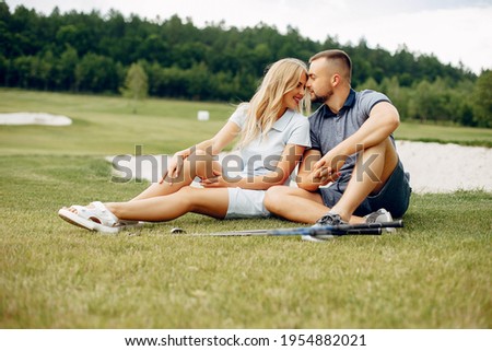 Beautiful couple playing golf on a golf course