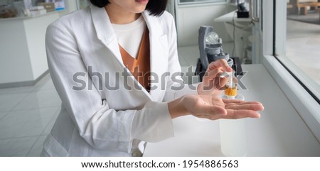 A doctor is demonstrated how to clean hand, used alcohol-gel and spray to clean hand, to protect from Coronavirus or Covid-19	
