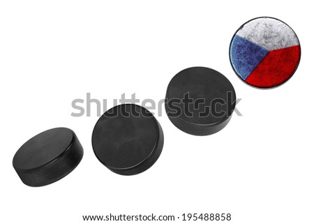 Czech hockey pucks lined up in a row on white background