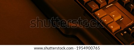Gaming computer keyboard on a dark background. Up and down buttons on a computer keyboard.