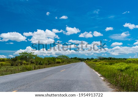 Small country road or street with blue sky background.