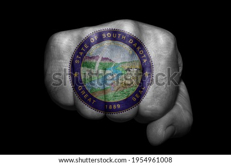 South Dakota Seal US country Flag painted on strong fist on black background