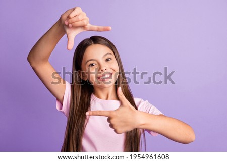 Photo of young cheerful girl happy positive smile make fingers border frame photographer cadre isolated over purple color background