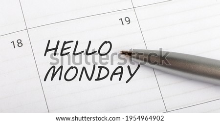 Text HELLO MONDAY written on a calendar planner to remind you an important appointment with pen on isolated white background.