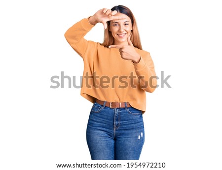 Beautiful young woman wearing casual clothes smiling making frame with hands and fingers with happy face. creativity and photography concept. 